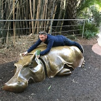 Dan hugging a hippopotamus statue