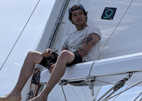 Dylan sitting on a sail boat