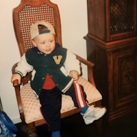 Dylan as a child sitting in a chair