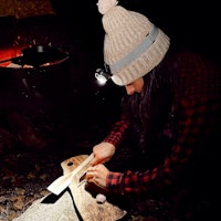 Jerrianne cutting an onion by the campfire