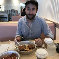 Lane having chicken and waffles at a local diner