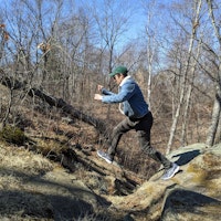Max jumping from rock to rock on a hike